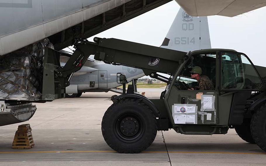 Lance Cpl. Elijah L. Gates loads a pallet of gear onto a KC-130J Hercules aircraft Sunday, Nov. 10, 2013, at Marine Corps Air Station Futenma, Okinawa, Japan, during preparation for a humanitarian assistance and disaster relief mission to the Philippines after Typhoon Haiyan.