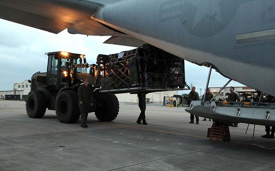 Marines load palletized equipment onto a KC-130J Hercules aircraft Monday, Nov. 11, 2013, at Marine Corps Air Station Futenma, Okinawa, Japan, during preparation for a humanitarian assistance and disaster relief mission to the Philippines after Typhoon Haiyan, which impacted millions of people across 36 provinces.