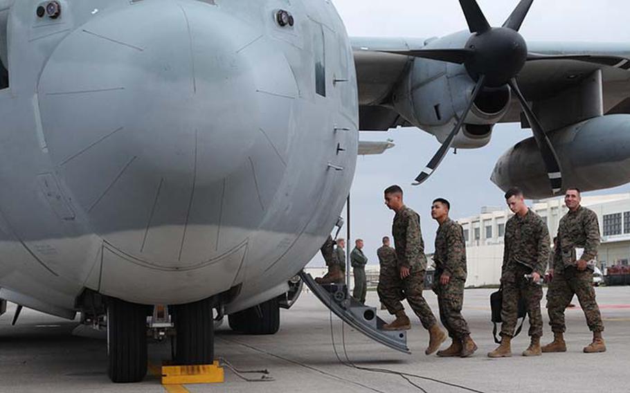 Marines board a KC-130J Hercules aircraft Sunday, Nov. 11, 2013, at Marine Corps Air Station Futenma, Okinawa, Japan, to depart for humanitarian assistance and disaster relief operations in the Philippines after Typhoon Haiyan.