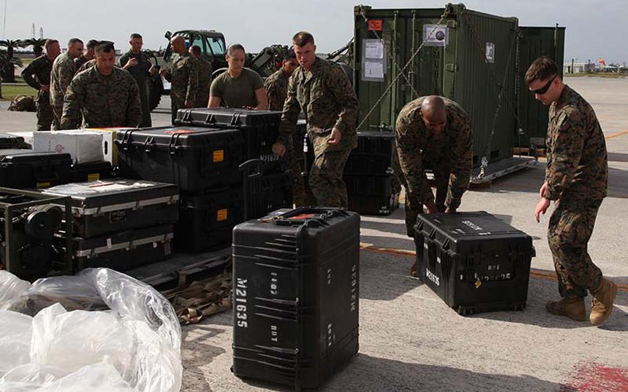 Marines preparing to depart for the Philippines ahead of Haiyan relief efforts stack their gear on a pallet Sunday, Nov. 10, 2013, at Marine Corps Air Station Futenma, Okinawa, Japan.