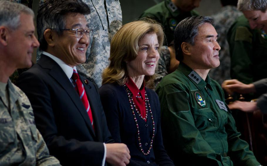 U.S. Ambassador to Japan Caroline Kennedy sits for a group photo with (from left to right) Lt. Gen. Salvatore Angelella, commander, US Forces Japan; Ryota Takeda, Japan Parlimentary Senior Vice Minister of Defense, Lt. Gen. Kunisuke Nakashima, Japan Air Self Defense Force vice chief of staff at Yokota Air Base, Japan, on Thursday, Nov. 21, 2013.