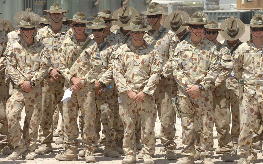 Australian soldiers participate in an August, 2010 ceremony commemorating their nation's efforts in the Vietnam war at Multinational Base Tarin Kot, Afghanistan. The Australian Defence Force has handed over control of the base to Afghan forces as part of its withdrawal from Afghanistan.
