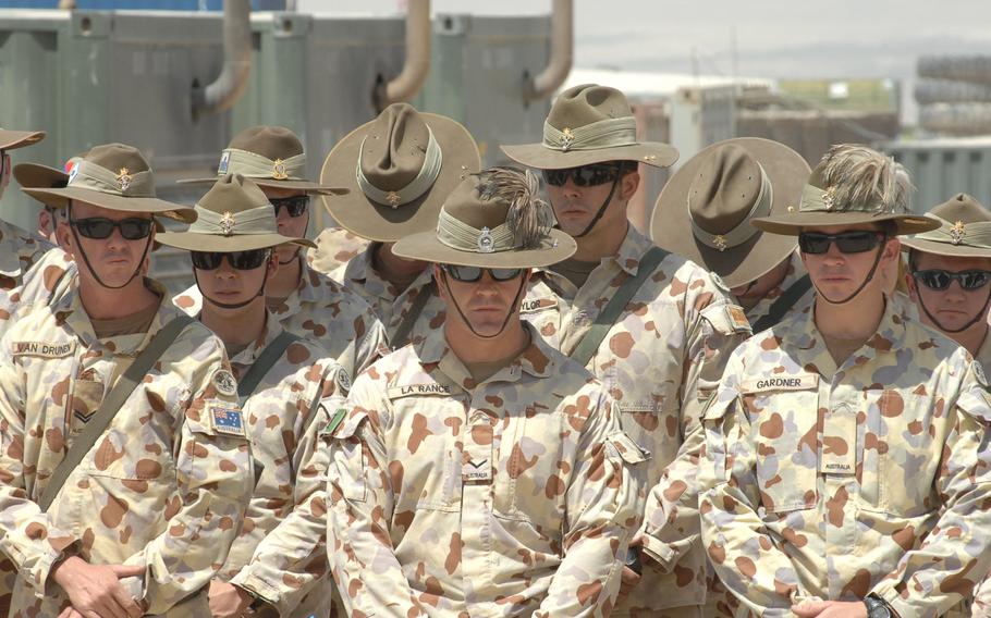 Australian soldiers participate in an August, 2010 ceremony commemorating their nation's efforts in the Vietnam war at Multinational Base Tarin Kot, Afghanistan.  The Australian Defence Force has handed over control of the base to Afghan forces as part of its withdrawal from Afghanistan.
