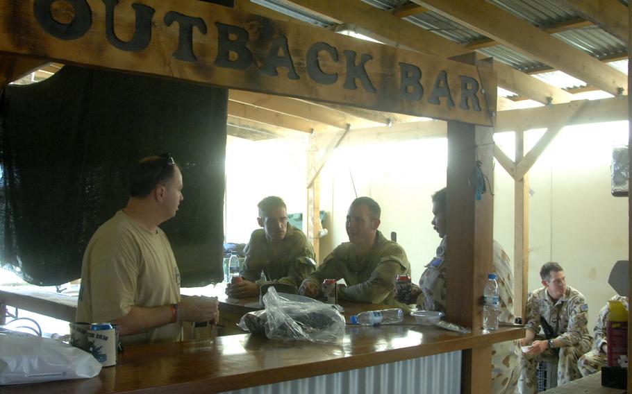 Australian soldiers relax at the "Outback Bar" at Multinational Base Tirin Kot, Afghanistan, in August 2010.  The Australian Defence Force has handed over control of the base to Afghan forces as part of its withdrawal from Afghanistan.
