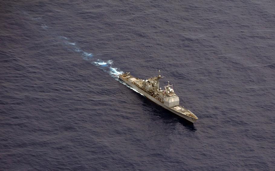 The USS Cowpens moves into position before firing missiles at a flying drone during a live fire weapons shoot in the western Pacific Ocean in this Sept. 2012 photo.