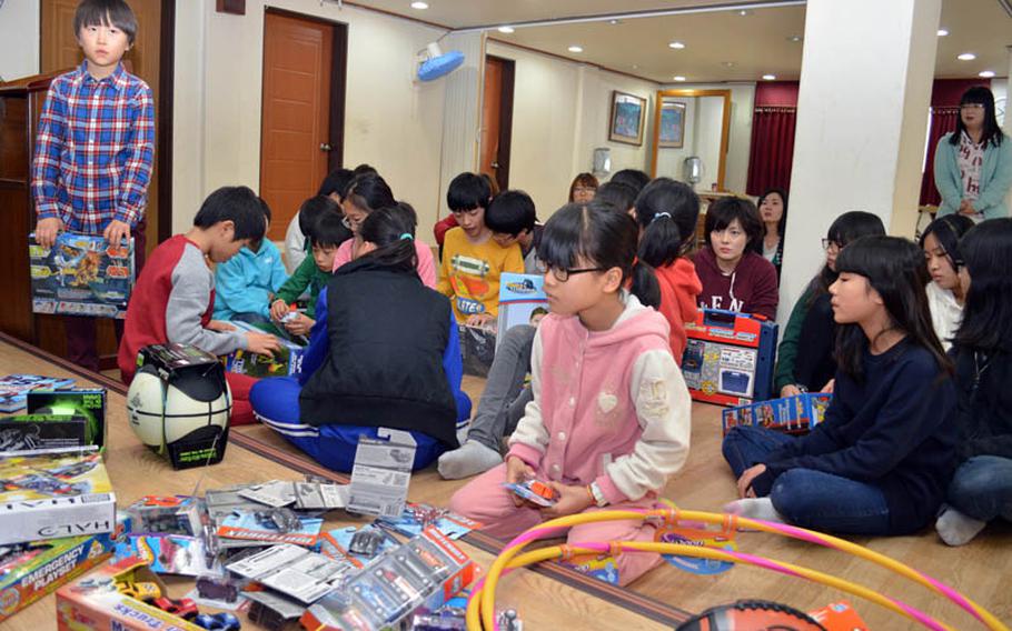 Children from Dream-Up Home orphanage select donated toys at Suwon, South Korea, on Dec. 22, 2013. Over 300 toys were donated by U.S. military personnel stationed in South Korea. 