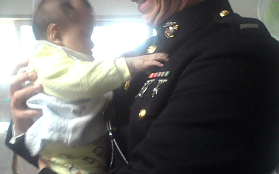 U.S. Marine 1st Lt. Daniel Bogan holds a South Korean baby at Samsungwon orphanage in Gumi, South Korea, on Dec. 21, 2013. Bogan was part of a group of Marine stationed in Korea delivering toys to children all over the Korean peninsula.