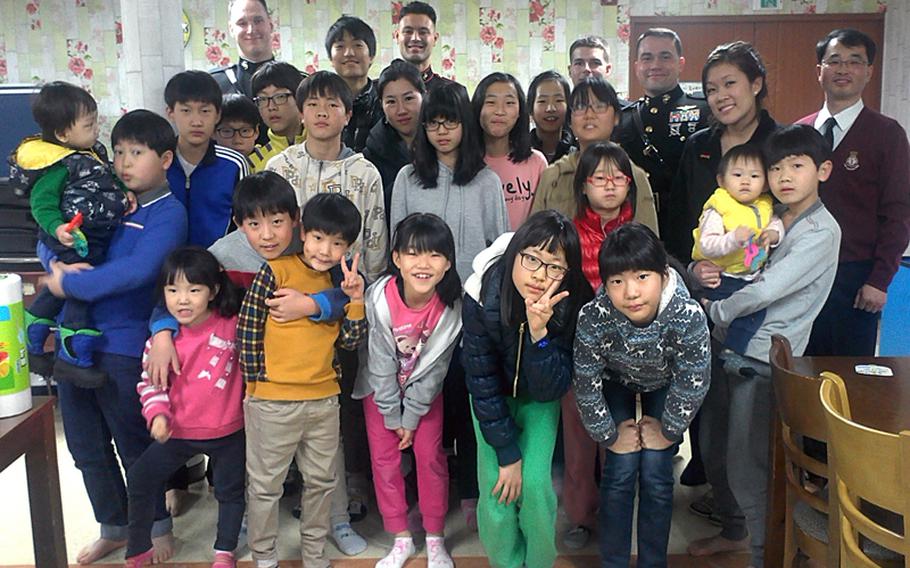 U.S. Marines pose for a group photo after delivering toys to Goo-saegun (Salvation Army) Daejeon Hyesaengwon in South Korea, on Dec. 21, 2013. Over 300 toys were delivered by Marines during the weekend of Dec. 22-23. 