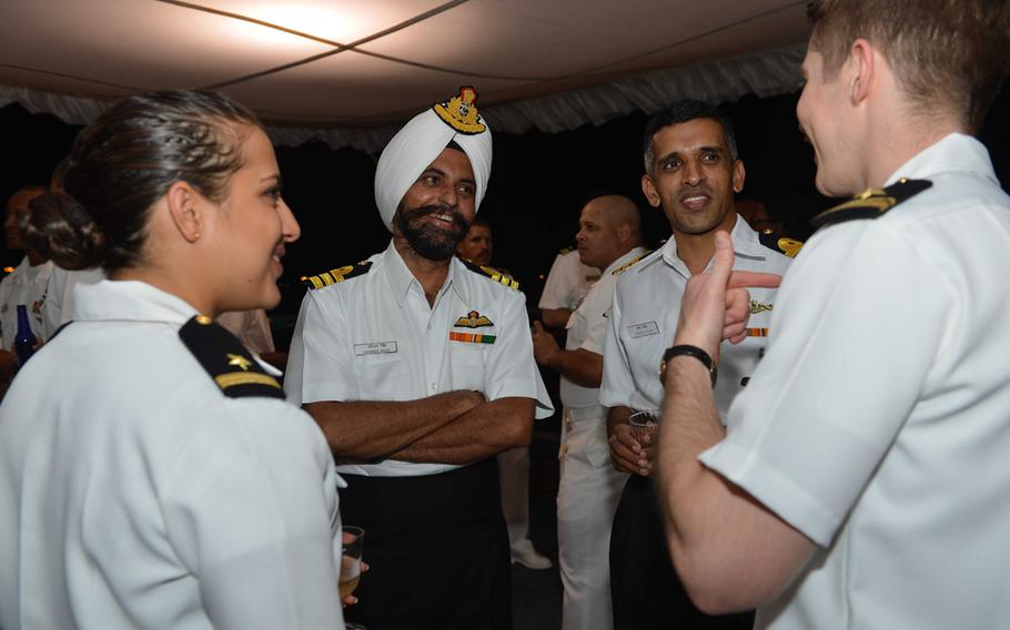Naval officers from the U.S. and India chat aboard the USS McCampbell during a reception for the exercise Malabar 13, Nov. 13, 2013.