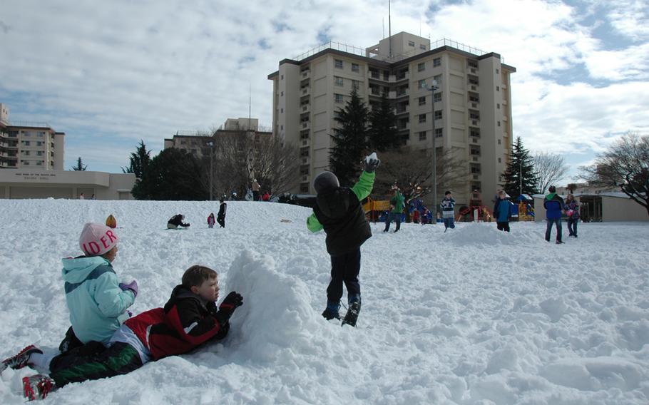 Kids battle with snowballs on Yokota Air Base Sunday morning, Feb. 9, 2014. 