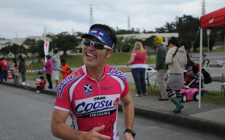Spirits remain high as runners reach the 31.6-kilometer marker of the Okinawa Marathon at Kadena Air Base, Okinawa, Feb. 16, 2014. 