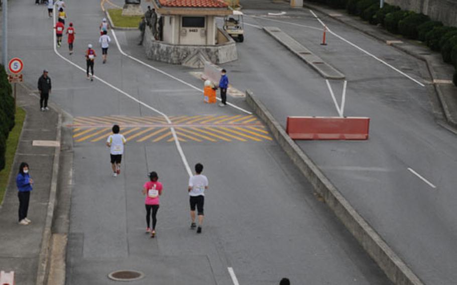 The race route stretches into the distance during the Okinawa Marathon at Kadena Air Base, Okinawa, Feb. 16, 2014. 