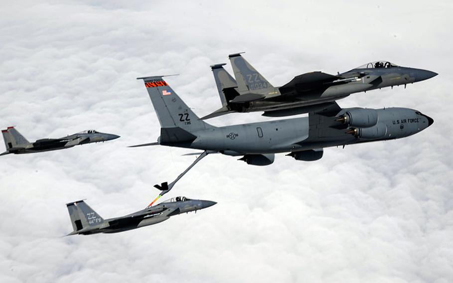 An Air Force KC-135 from the 909th Air Refueling Squadron refuels a 44th Fighter Squadron F-15 Eagle while two other F-15s fly in formation during a training mission over Okinawa, Japan, on April 5, 2013.