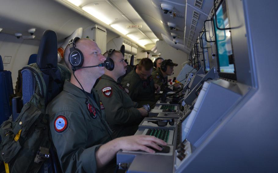 Crew members on board a P-8A Poseidon assigned to Patrol Squadron (VP) 16 man their workstations while assisting in search and rescue operations for Malaysia Airlines flight MH370. VP-16 is deployed in the U.S. 7th Fleet area of responsibility supporting security and stability in the Indo-Asia-Pacific.
