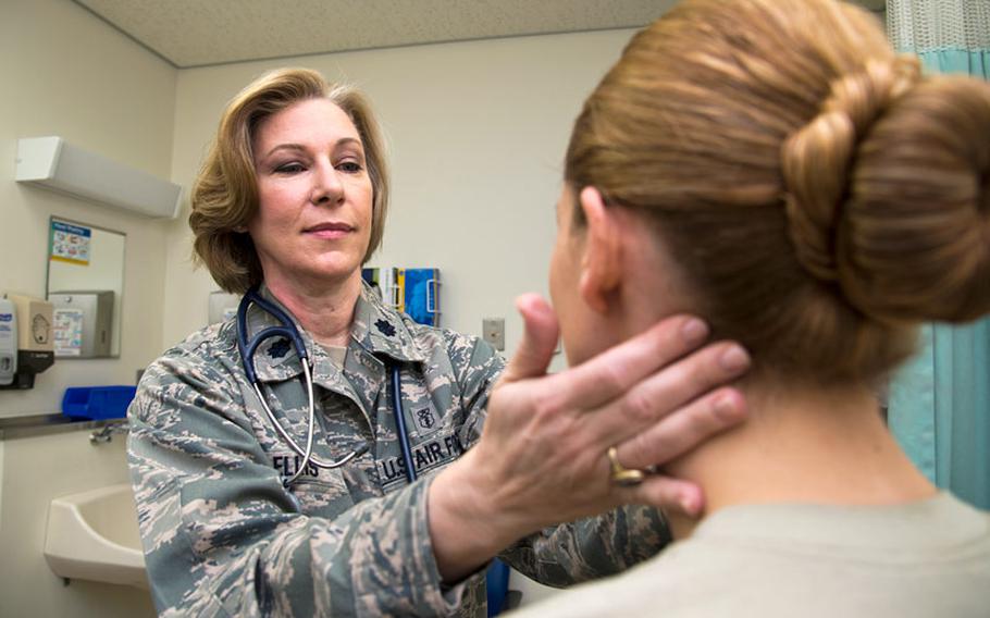 Lt. Col. Melanie Ellis examines a patient Mar. 14, 2014, at Misawa Air Base, Japan. Ellis, the 35th Medical Operations Squadron commander, has been recognized for her mentorship, experience and accomplishments in her 21-year career as a physician assistant.