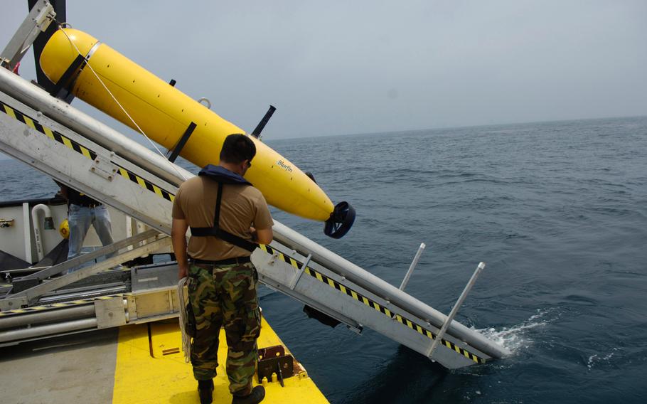 Chief Aerographer's Mate Trung Freed, from Naval Mine and Anti-Submarine Warfare Command, Corpus Christi, Texas, monitors the deployment of a Bluefin Autonomous Underwater Vehicle during testing  in 2007.