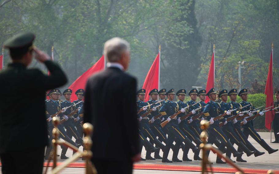 U.S. Secretary of Defense Chuck Hagel, right, and Chinese People's Liberation Army Gen. Chang Wanquan, the Chinese minister of defense, watch a pass in review during an honors ceremony April 8, 2014, in Beijing. 