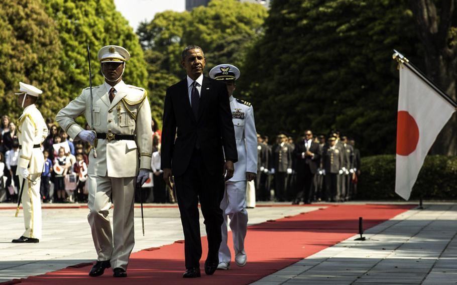 President Barack Obama reviews troops from the Japanese Self-Defense Force during a welcome ceremony as he arrived at the Imperial Palace in Tokyo, Thursday, April 24, 2014. 