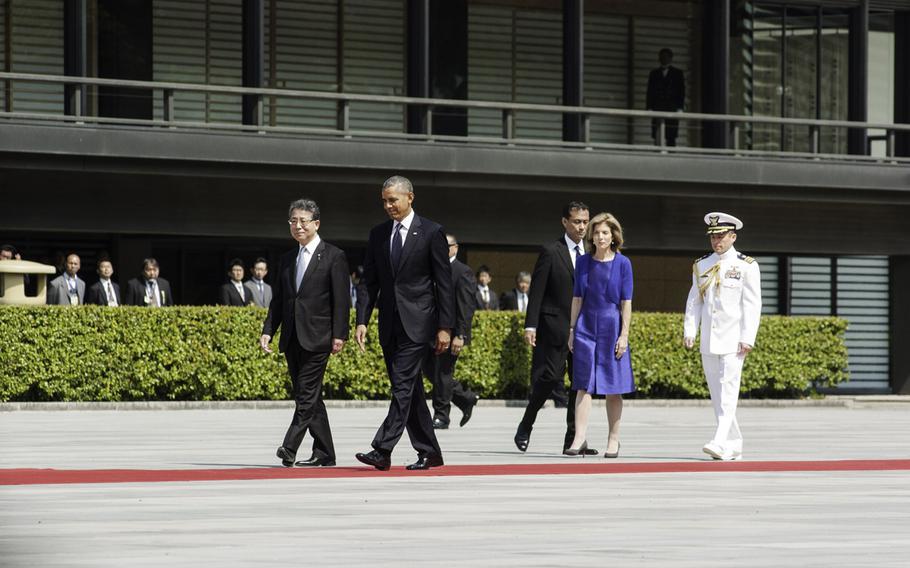 President Barack Obama, followed by U.S. Ambassador to Japan Caroline Kennedy, walks the red carpet after a welcoming ceremony with Emperor Akihito at the Imperial Palace in Tokyo, April 24, 2014.