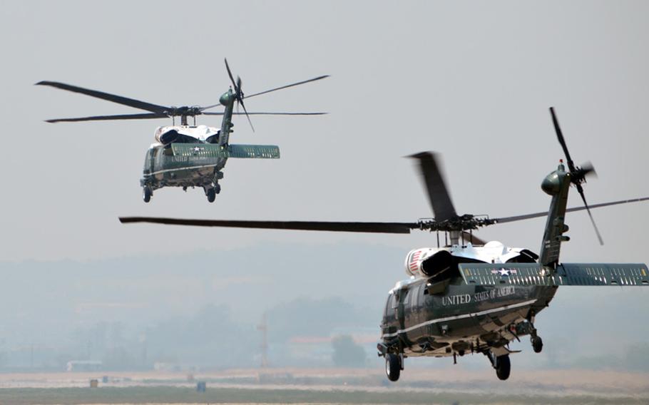 Marine One, left, lifts off from Osan Air Base, South Korea, to take President Barack Obama on his 2-day tour in Seoul on Friday, April 25, 2014.