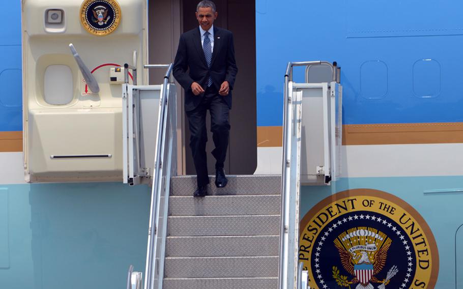 President Barack Obama steps down from Air Force One at Osan Air Base, South Korea, on Friday, April, 2014. After wrapping up a 2-day tour in Tokyo, Obama was scheduled to meet South Korean President Geun-hye Park later Friday and attend a wreath-laying ceremony at the National War Memorial in Seoul.