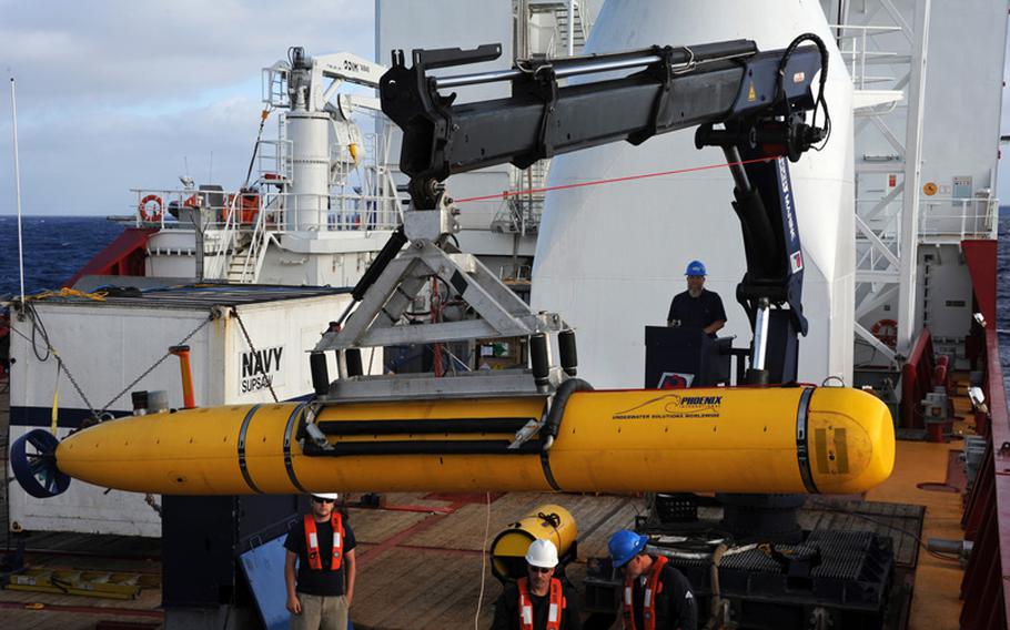 Operators aboard the Australian navy vessel ADF Ocean Shield move U.S. Navy's Bluefin-21 underwater drone into position for deployment on April 14, 2014, during a search for debris from Malaysia Airlines Flight 370.