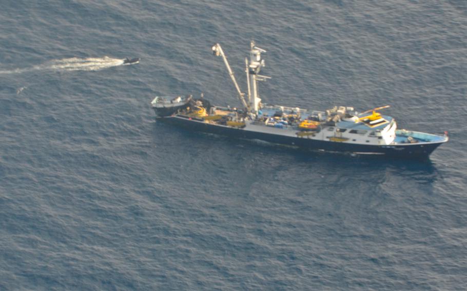 A team of U.S. Air Force pararescue airmen make their way in a zodiac inflatable boat to provide lifesaving care to Chinese sailors aboard a Venezuelan fishing ship in the Pacific Ocean, May 3, 2014. 