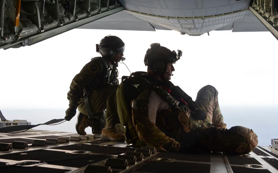 Members of the U.S. Air Force pararescue team before jumping into the Pacific Ocean to aid to two critically injured sailors aboard a Venezuelan fishing boat May 3, 2014. 