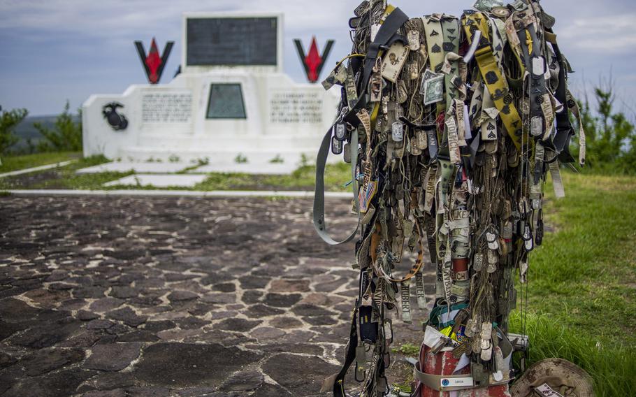 Name tape, rank and other tributes adorn the way to the monument where U.S. Marines planted the American flag atop Mount Suribachi in 1945, following the hard-fought Battle of Iwo Jima.
