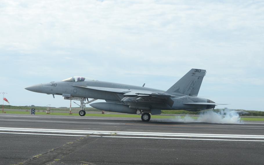 An F-18 fighter jet assigned to the USS George Washington's carrier air wing executes a touch-and-go landing at Iwo To, historically known as Iwo Jima, on May 14, 2014. Despite its isolation and unpredictable weather, the Navy uses the island for its mandatory field carrier landing practice.
