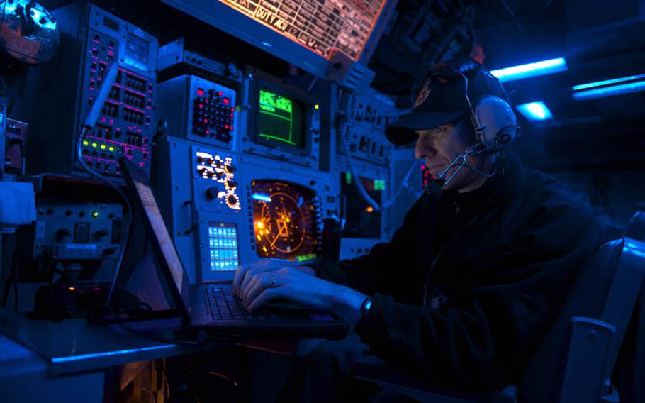 Chief Fire Controlman Daniel Glatz, from Green Bay, Wisconsin, stands watch in the combat information center aboard the Arleigh Burke-class guided-missile destroyer USS John S. McCain (DDG 56). John S. McCain is on patrol with the George Washington Carrier Strike Group in the 7th Fleet area of operations supporting security and stability in the Indo-Asia-Pacific region. Alonzo M. Archer/U.S. Navy