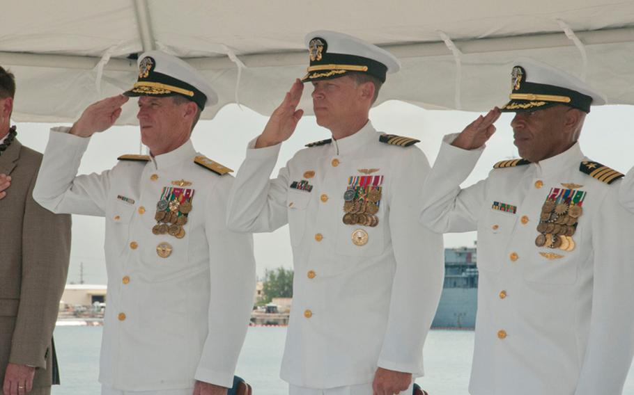 From left: Rear Adm. Tilghman Payne, Commander, Joint Region Marianas; U.S. Naval Base Guam (NBG) outgoing Commanding Officer Capt. Mike Ward; and incoming Commanding Officer Capt. Andy Anderson render salutes as colors are posted during NBG's change of command ceremony at the Tango/Uniform Wharf at the base in Santa Rita June 20. Anderson relieved Ward as the base commanding officer. 