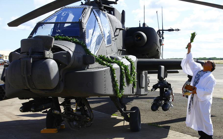 An Apache Guardian attack helicopter receives a Hawaiian blessing after eight of them arrived in Oahu on Friday. Four of the aircraft will be moved deeper into Asia at the end of the summer as part of the Army's Pacific Pathways initiative.