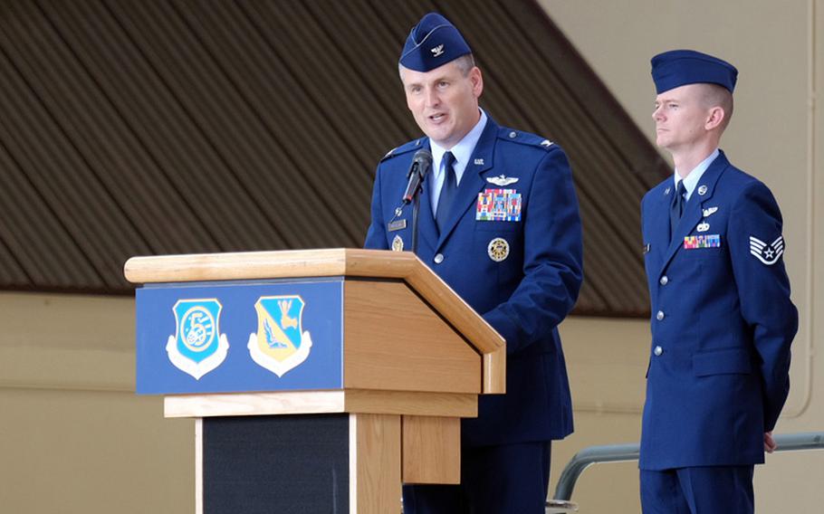Col. Douglas C. Delamater addresses the audience after taking command of the 374th Airlift Wing on June 26, 2014, during a change of command ceremony at Yokota Air Base, Japan. Delamater relieved Col. Mark "Buzz" August as commander of the US military's only airlift wing in the Pacific.