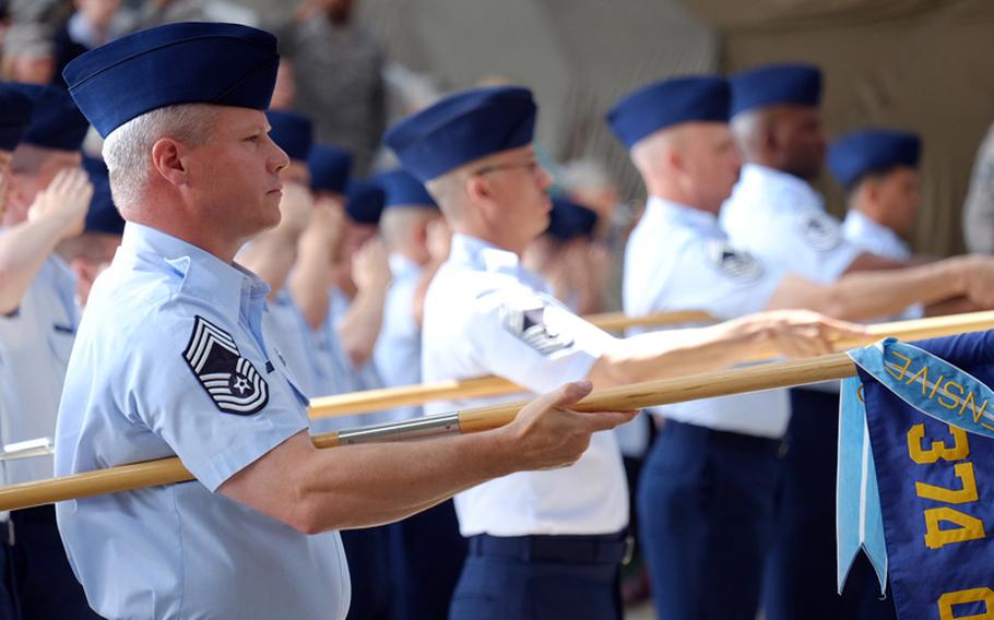 Airmen from the 374th Airlift Wing salute the new wing commander during a change of command ceremony June 26, 2014, at Yokota Air Base, Japan. 