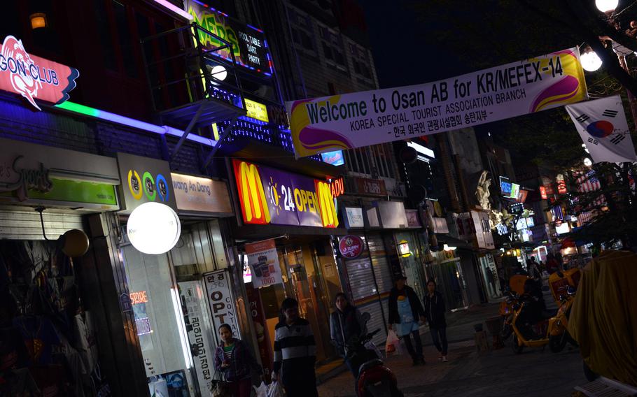 A Korea Special Tourist Association banner welcomes potential patrons in the Sinjang-dong Shopping Mall outside Osan Air Base, South Korea on April 6, 2014. Numerous bars, restaurants and clothing stores fill the shopping area. What's missing are the infamous juicy bars that used to be part of the landscape.
