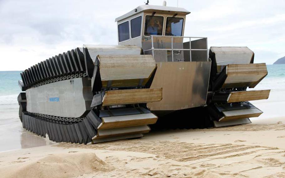 The Ultra Heavy-lift Amphibious Connector, or UHAC, clambers out of the sea onto an Oahu beach during a demonstration by the Marines on July 11, 2014.