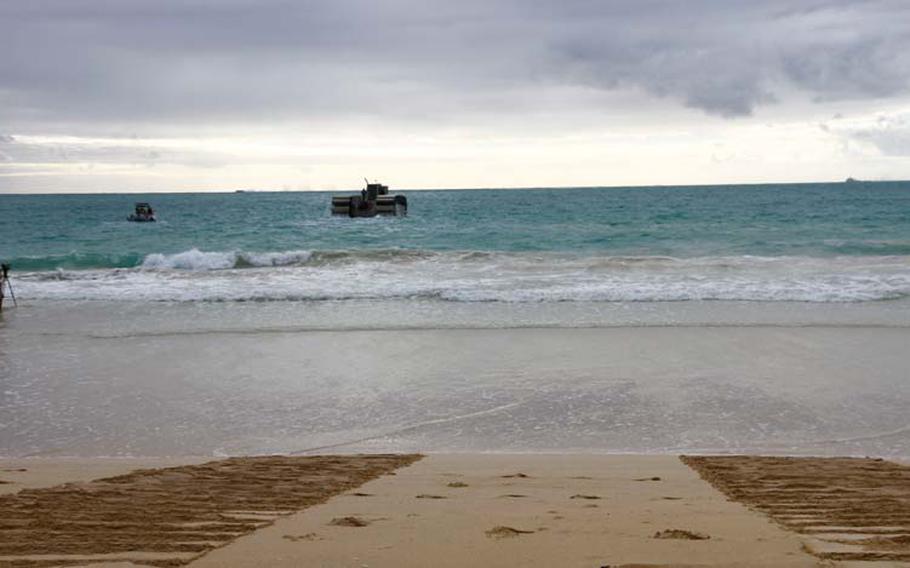 The tracks of the Ultra Heavy-lift Amphibious Connector, a prototype craft being tested this month by the Marines in Hawaii during the Rim of the Pacific exercises, are seen on an Oahu beach as it heads out into the ocean Friday, July 11, 2014.