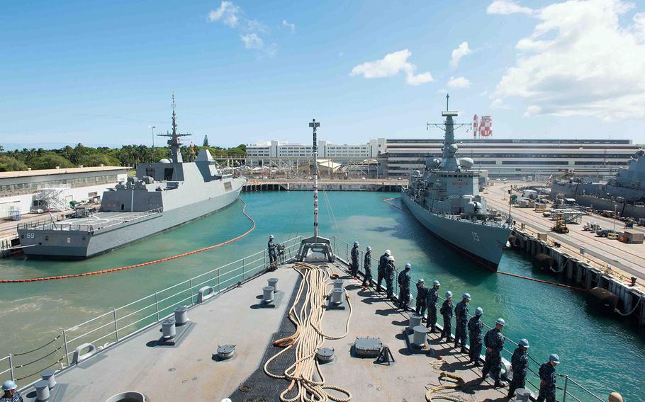 Sailors man the rails as the amphibious dock landing ship USS Rushmore departs Joint Base Pearl Harbor-Hickam for RIMPAC, July 8, 2014. 