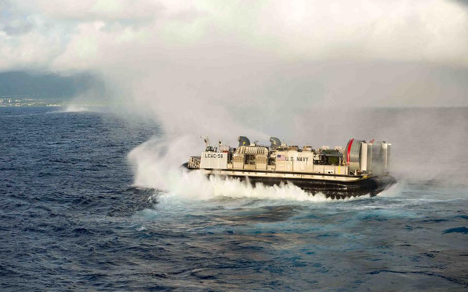 A landing craft air cushion, assigned to Assault Craft Unit 5, departs the amphibious dock landing ship USS Rushmore for an equipment transfer during RIMPAC, July 9, 2014. 