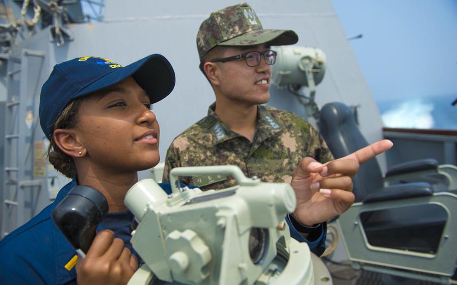 Electronic Technician 1st Class Christopher Williams, from Simi Valley, California, left, assigned to the Arleigh Burke-class guided-missile destroyer USS Kidd (DDG 100), stands watch with Republic of Korea navy Lt. Donghoon Lee during bilateral operations. Kidd is currently on patrol in the U.S. 7th Fleet area of responsibility supporting regional security and stability in the Indo-Asia Pacific region. 