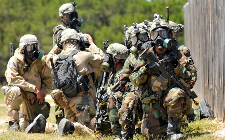 Soldiers of the 3rd Battalion, 8th Cavalry Regiment, 3rd Brigade Combat Team, 1st Cavalry Division and 48th Chemical Brigade prepare to approach a simulated chemical threat July 13, 2014, while conducting training at the military operations on urban terrain site Boaz at Fort Hood, Texas. Training such as this and Exercise Fortune Guard, which begins Aug. 4 in Hawaii, is intended to develop skills in detecting and neutralizing weapons of mass destruction. 