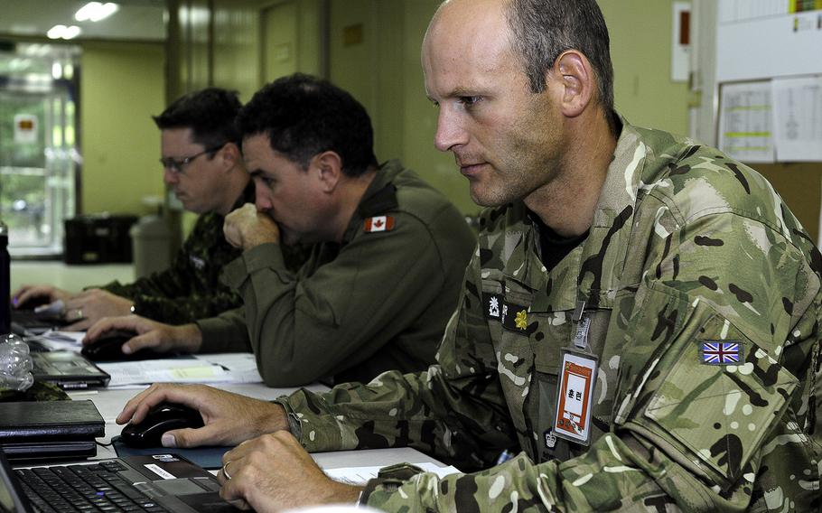 Maj. Will Taylor, a British exchange officer attached to 1st Canadian Division, monitors his screen for possible enemy movement on the battlefield during Exercise Ulchi Freedom Guardian 2014 at Camp Yongin, South Korea, on Tuesday, Aug. 26, 2014.