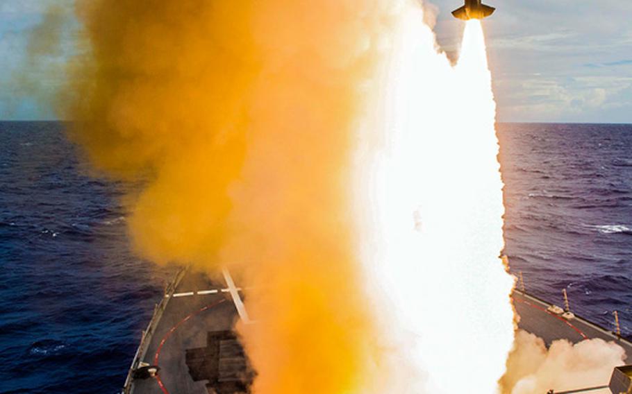 The Arleigh Burke-class guided-missile destroyer USS Mustin fires an SM-2 missile during Exercise Valiant Shield 2014. Air and sea units from the U.S. Navy, Marine Corps and Air Force participated in the sinking exercise of ex-USS Fresno to gain proficiency in tactics, targeting and live firing against a surface target at sea in conditions that couldn't be simulated otherwise. 