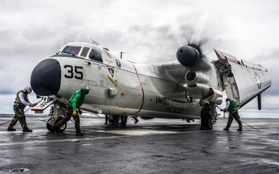 Sailors chock and chain a C-2A Greyhound from the Providers of Fleet Logistics Support Squadron 30, Detachment 5, on the flight deck of the forward deployed aircraft carrier USS George Washington. George Washington is currently participating in Valiant Shield 2014, a U.S.-only exercise integrating an estimated 18,000 Navy, Air Force, Army and Marine Corps personnel, more than 200 aircraft and 19 surface ships, offering real-world joint operational experience to develop capabilities that provide a full range of options to defend U.S. interests and those of its allies and partners. 