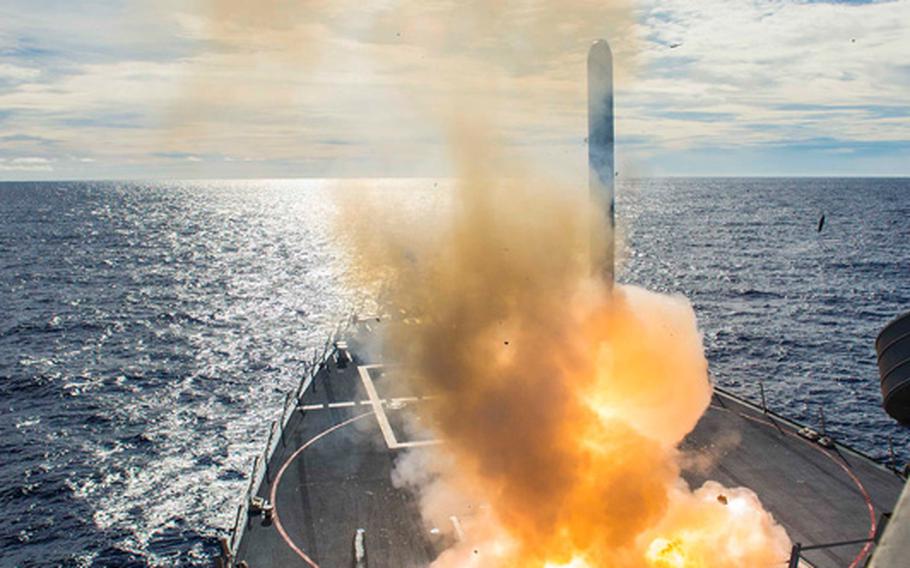 The Arleigh Burke class guided missile destroyer USS Mustin fires a Tomahawk Land Attack Missile simulating a joint strike on an enemy shore facility during Valiant Shield 2014.
