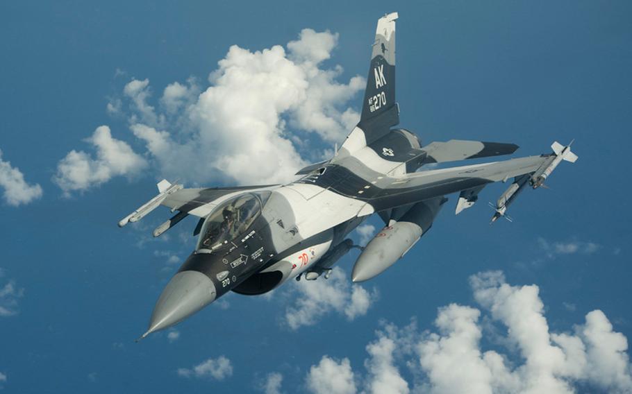 A U.S. Air Force F-16C Fighting Falcon from the 18th Aggressor Squadron, Eielson Air Force Base, departs after refueling from KC-10 Extender from the 32nd Air Refueling Squadron, Joint Base McGuire-Dix-Lakehurst during Valiant Shield 2014.