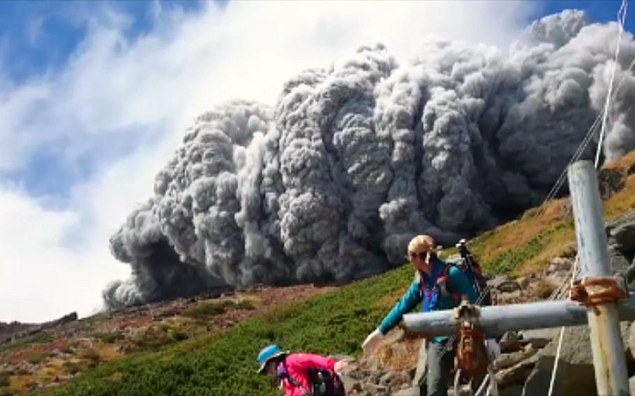 A video screen grab shows hikers scrambling down Mount Ontake, Japan, after it erupted on Saturday, Sept. 27, 2014.  The ash cloud would over take the hikers in a matter of seconds. Just before the 90-second video clip ends, hikers can be heard coughing as they are engulfed in swirling ash.