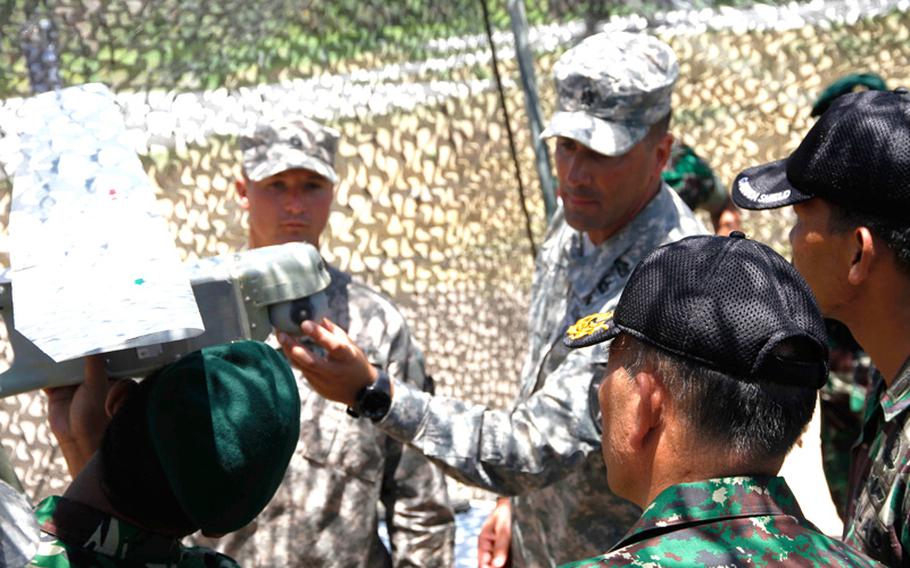 Lt. Col. Michael Trotter, commander of 2nd Battalion, explains the features of the Raven aerial drone to a group of Indonesian officers visiting the Garuda Shield exercise Sept. 24. The hand-launched Raven was one of a number of aircraft brought by the U.S. Army to Indonesia for training purposes.