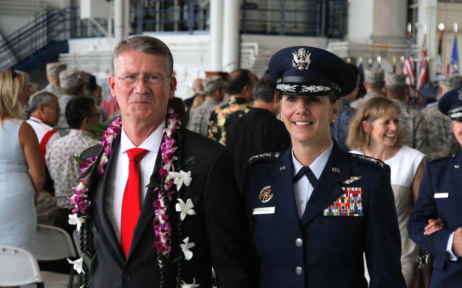 Air Force Gen. Lori Robinson departs the ceremony Thursday at which she became commander of U.S. Pacific Air Forces, marking the first time a woman has been appointed general of a joint forces air component command. To the left is her husband, David Robinson, a retired major general.